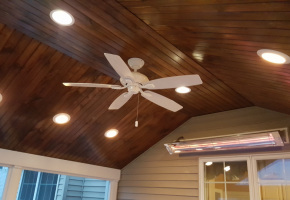 Clipped Cathedral Ceiling with Stained Pine Beadboard Ceiling and Recessed Lighting and Fan. Wall mount Infrared Heater to extend teh season!!!